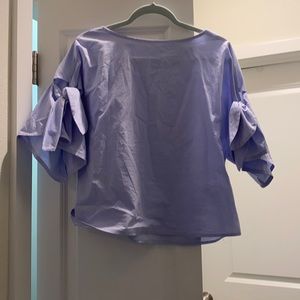 Swoop neck blue blouse with tie sleeves